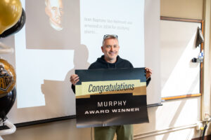 Steve Hallett holding Congratulations sign.