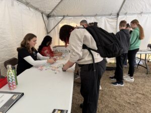 People lining up for their plant necklaces