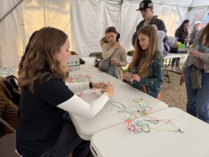 People lining up for plant necklaces