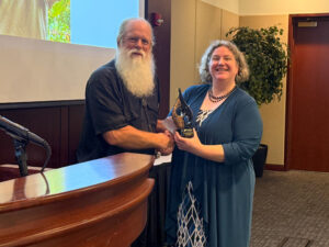 David Doud accepting award from Linda Prokopy.