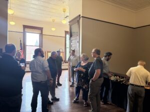 Audience mingling after remarks.
