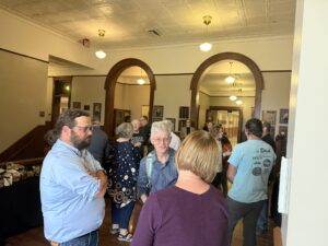 Audience mingling after remarks.