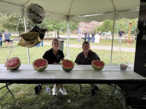 Katelyn Rockey and Rachael Carter sitting at the HLA Table.