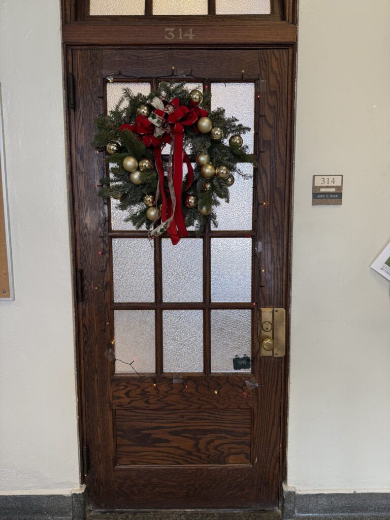 John Orick's door with lights and a wreath.