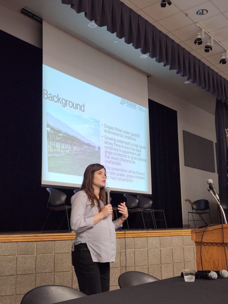 Miranda Purcell presents a session on table grapes, featuring a grape-under-high-tunnel demonstration done at the Purdue Student Farm.