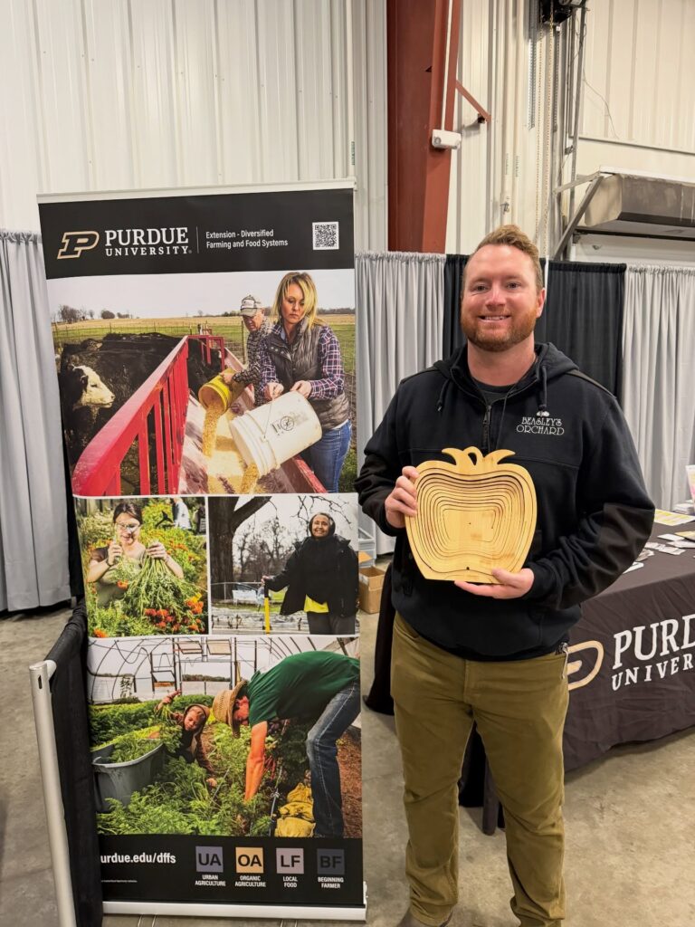 Calvin Beasley accepts Beasley's Orchard's first place award for the 2026 Cider Cider Contest.