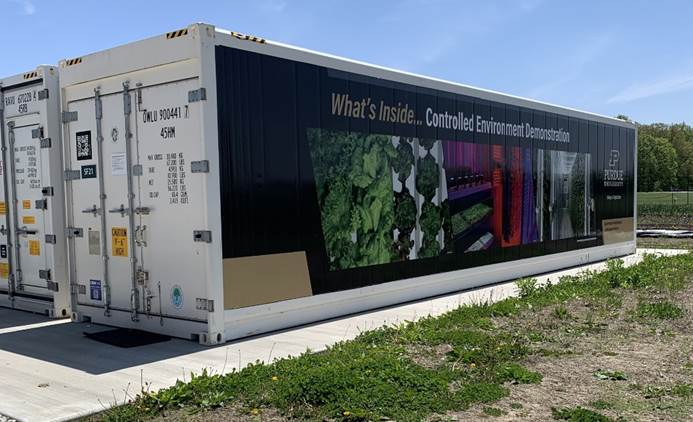 Exterior view of a Purdue University controlled-environment agriculture demonstration unit housed in a modified shipping container.