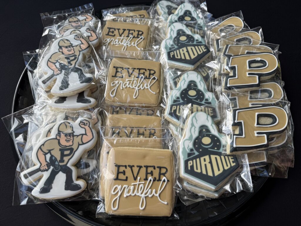 Assorted decorated cookies featuring Purdue logos, the Purdue Pete mascot, and “Ever grateful” designs individually wrapped for an event.