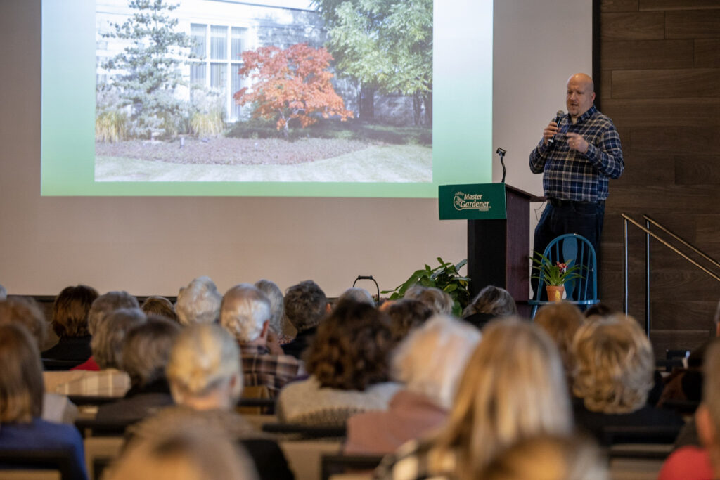 Speaker at podium talking to an audience.