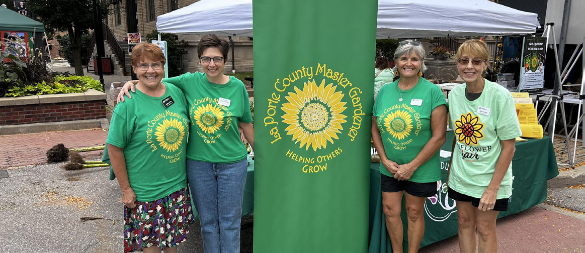 LaPorte County volunteers standing next to their organization's banner.