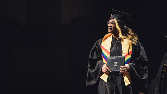 Purdue University student holding diploma.