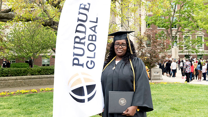 Purdue Global graduate in cap and gown.