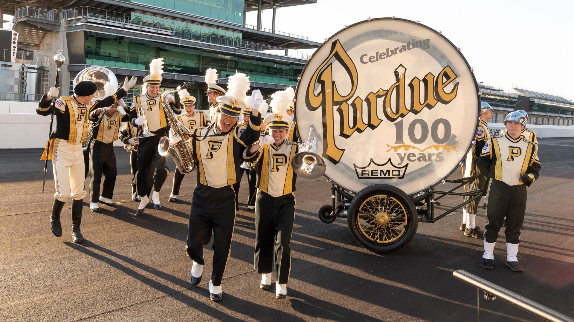The Purdue University band with the world's largest drum on the Indianapolis Motor Speedway track in front of the pagoda.
