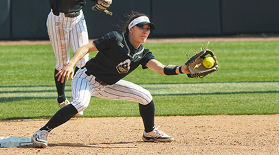 A Purdue Boilermakers softball player catching a ball.