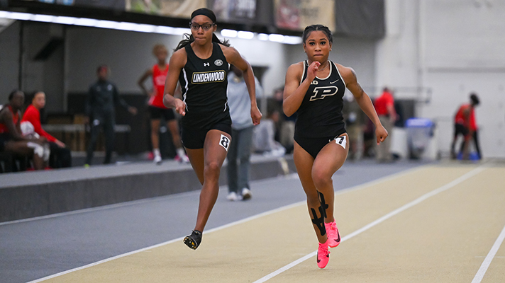 A Purdue track and field runner competing at a meet.