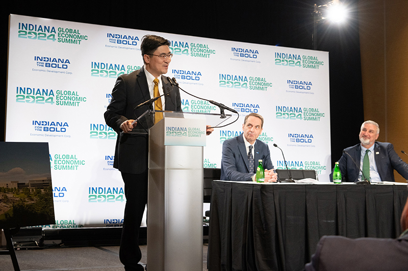 Purdue President Mung Chiang, alongside Indiana Gov. Eric Holcomb (right) and Elanco CEO Jeffrey Simmons (center), discusses the new One Health Innovation District during Thursday's announcement at the Indiana Convention Center.