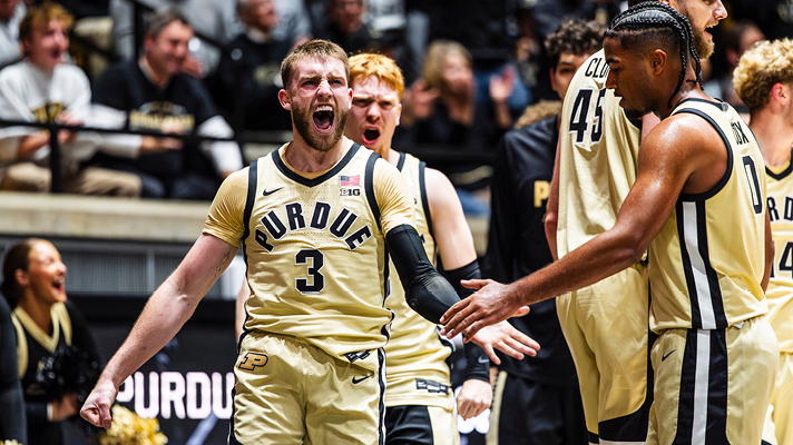 Purdue basketball players cheering.