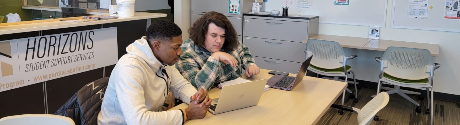 banner image: students sit at desk working together on a laptop