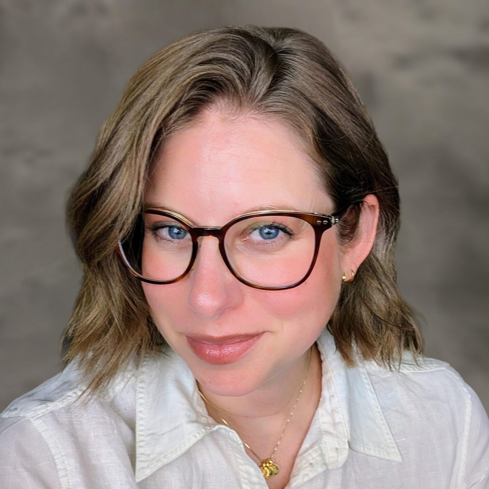Woman wearing glasses and white collared shirt
