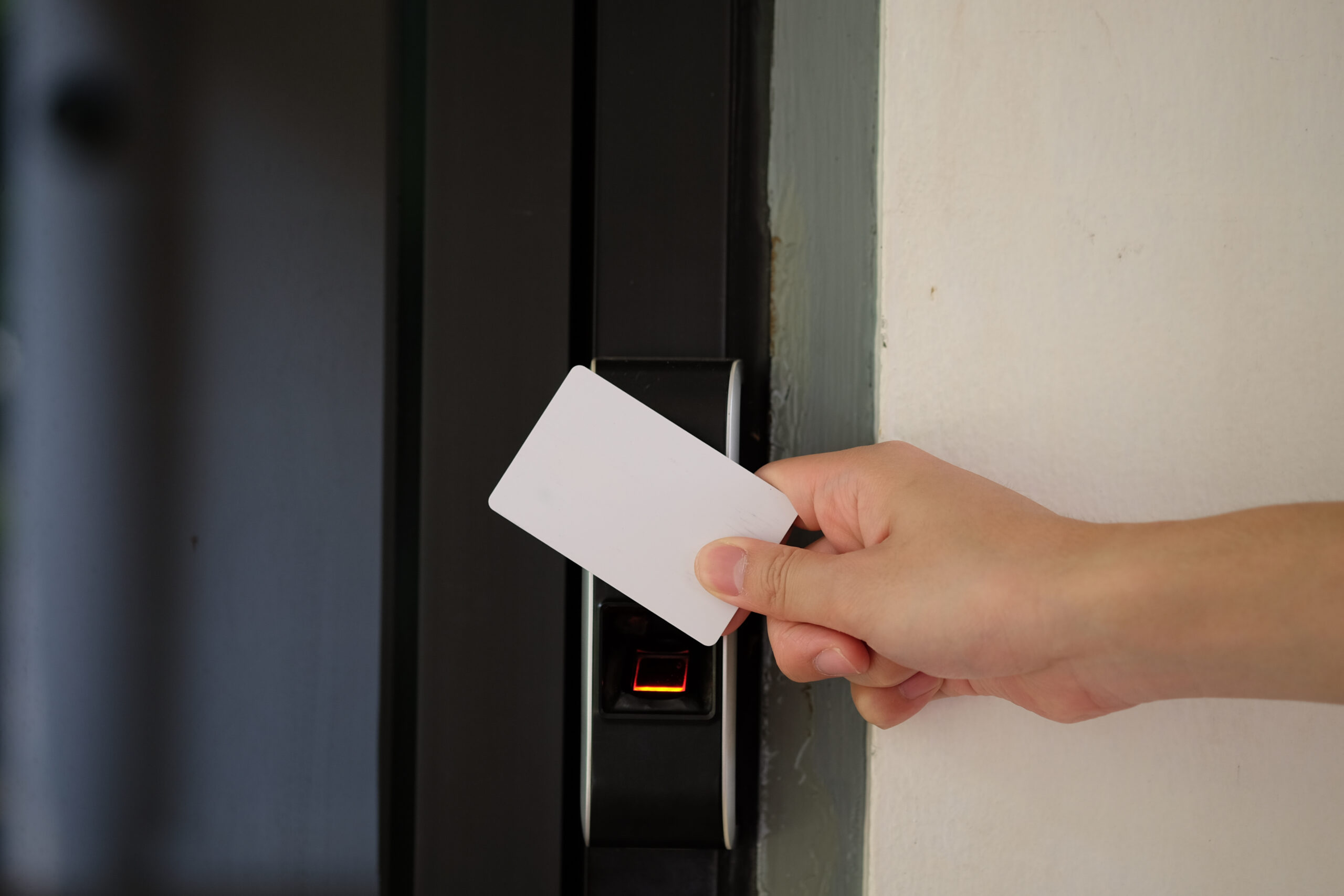 Door access control with a hand inserting key card to unlock door