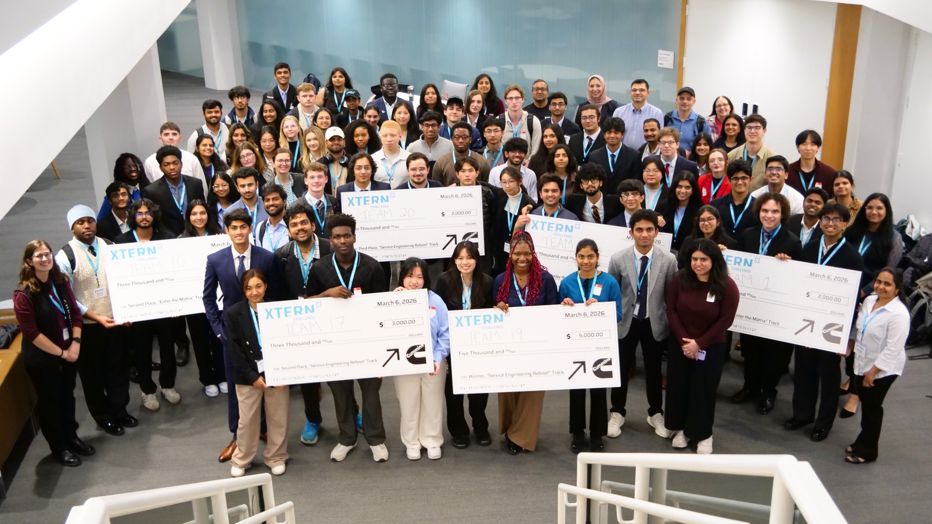 Purdue University students and partners pose with oversized checks at Cummins headquarters during TechPoint’s 2026 Xtern Challenge