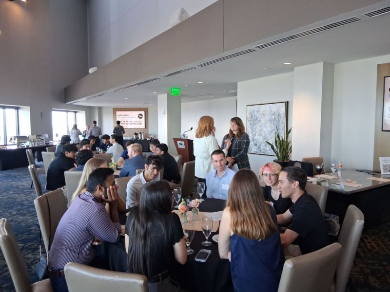 Students gathered in tables talking to each other