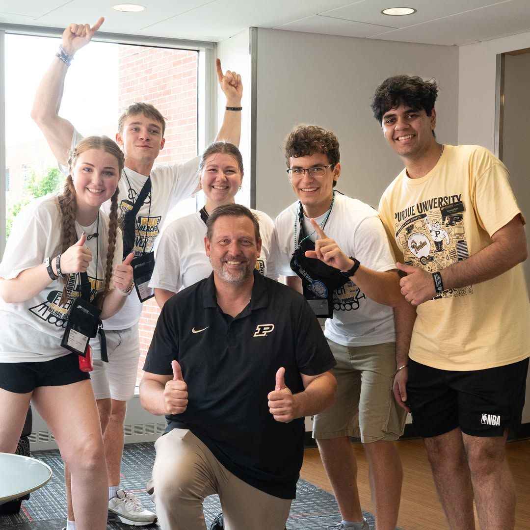 Senior Vice Provost for Indianapolis posing in front of five students