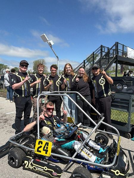 Student and Kart 24 teammates celebrate with their go-kart at the Purdue Grand Prix track.