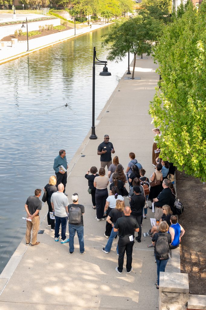 A group gathers along the Central Canal during a guided tour in Indianapolis.