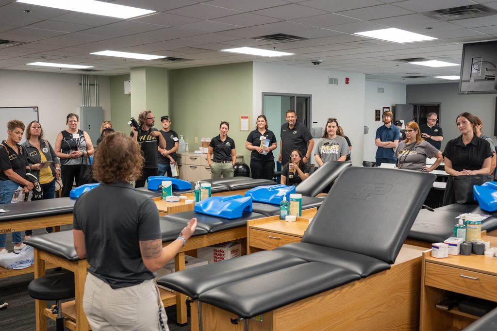 Visitors listen to a speaker in an instructional laboratory.