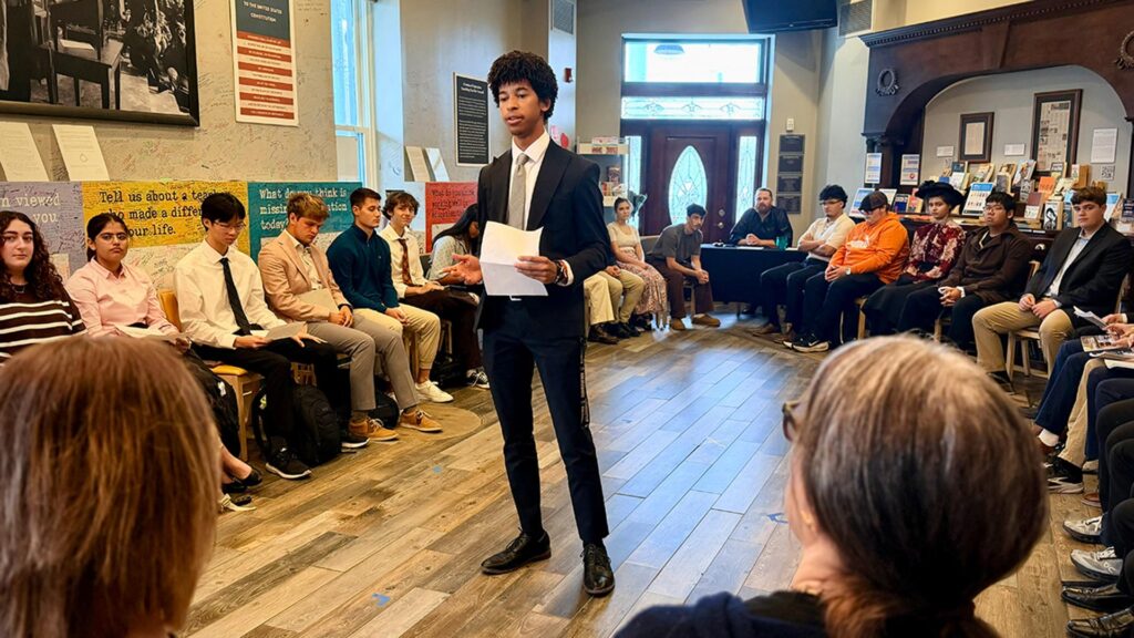 A student giving opening remarks in Frankenstein’s trial.