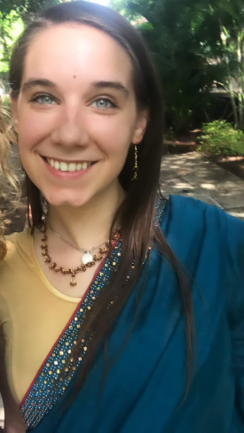 Claire LeMonnier wears a traditional Indian outfit and smiles