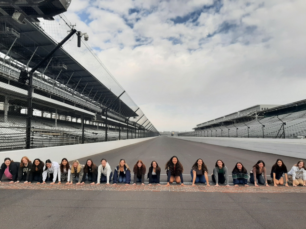 WIE LC Students participating in the kiss the bricks tradition at Indianapolis Motor Speedway