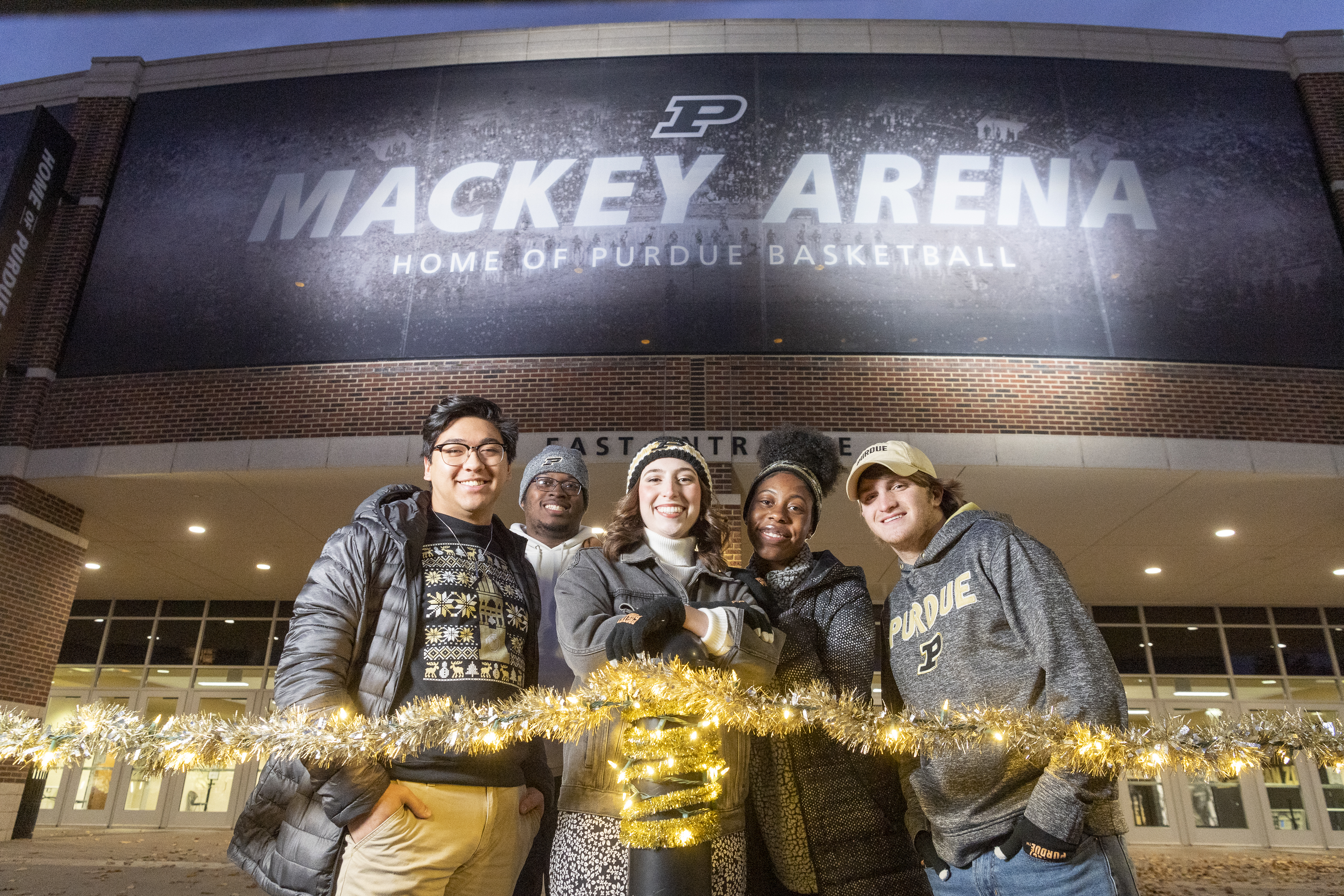 Students act out scenes in front of Mackey Arena. 