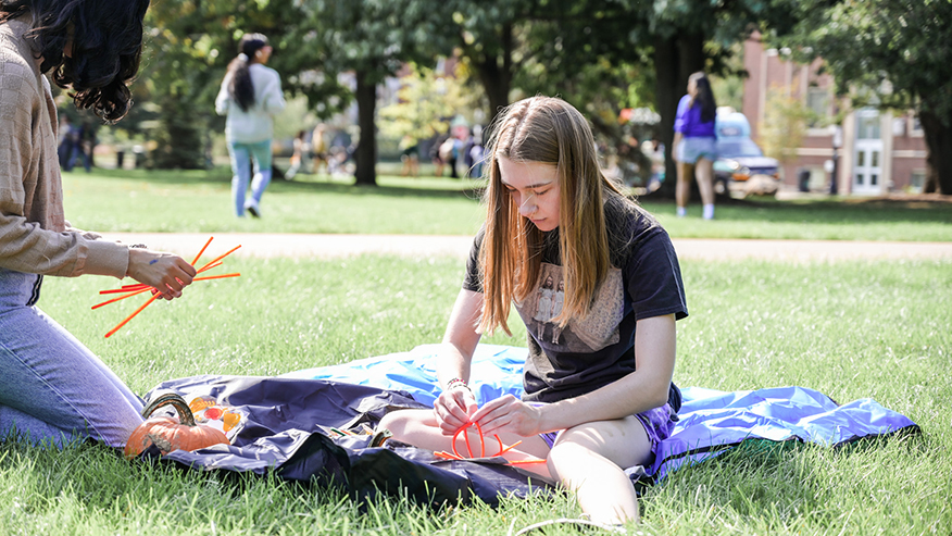 Student making a pumpkin craft