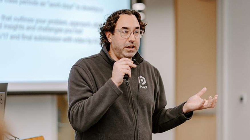 Michael Witt standing in front of classroom