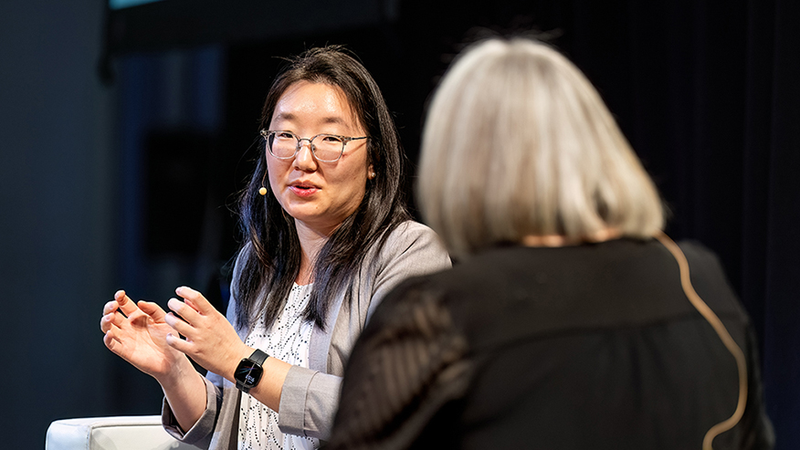 Two women speaking on stage