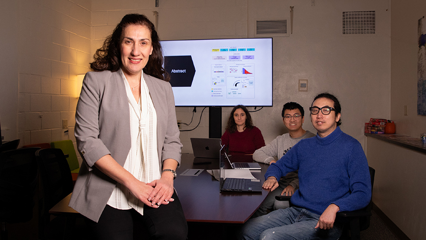 Group gathered around table with woman in front