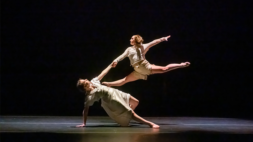 Two performers dance on stage