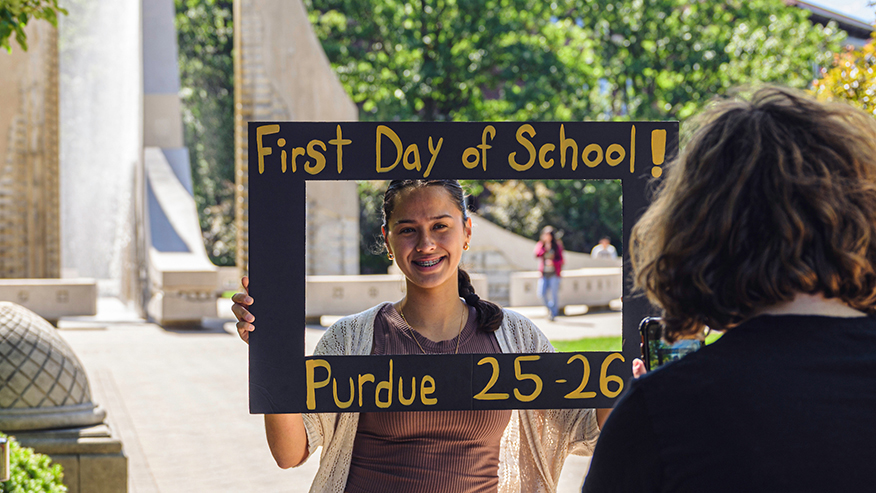 Young woman posing for photo on first day of school