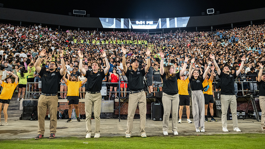 Students leading chant in front of crowd
