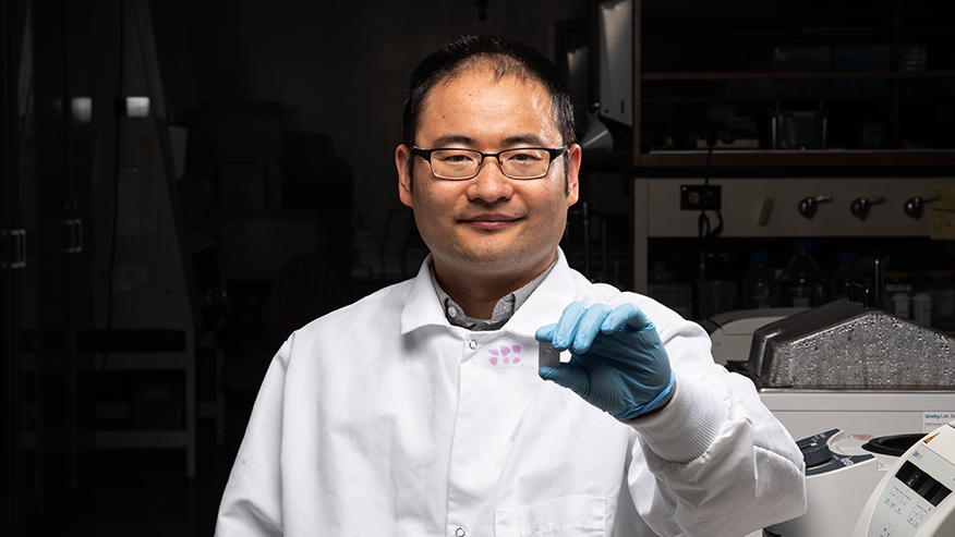 Researcher holding slide