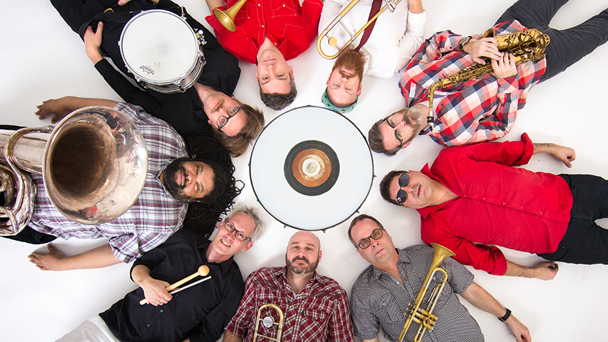 Band laying down with their instruments