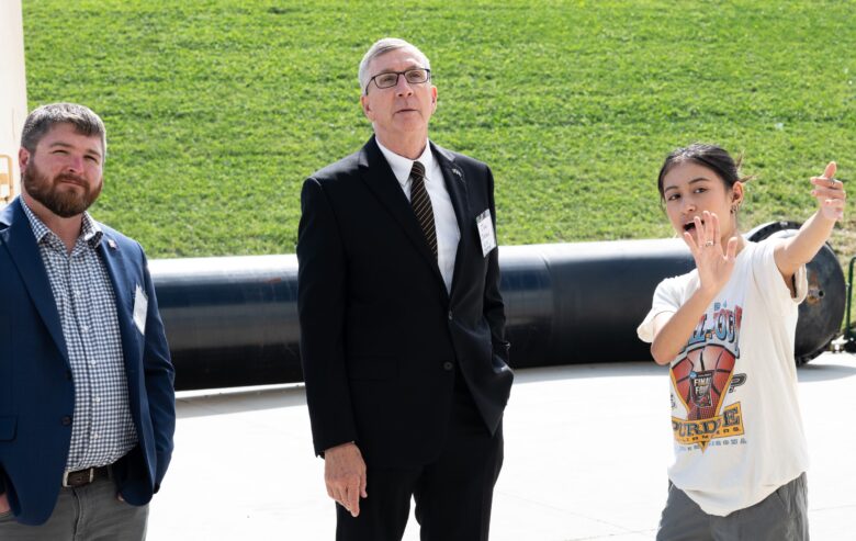 Matt Commons and Jack Jordan look up as Zoe Slatkin gestures.