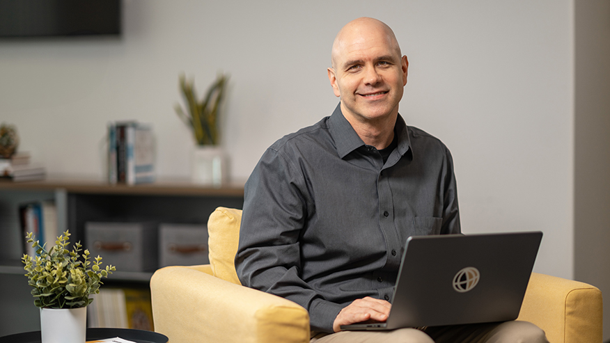 Man smiling with laptop