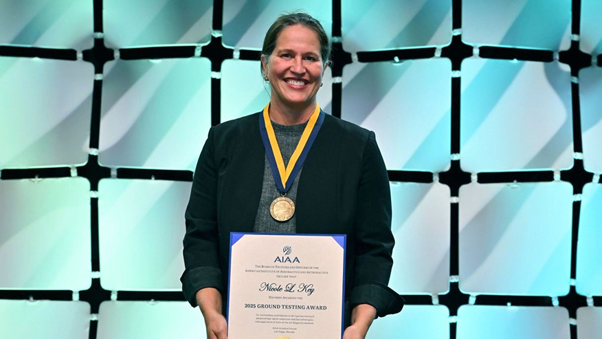 Woman holding paper award