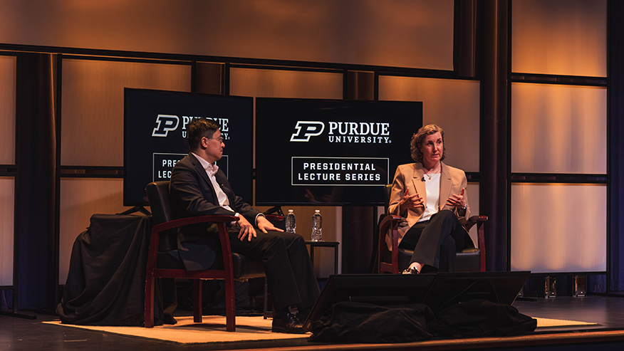 Two people sitting on stage