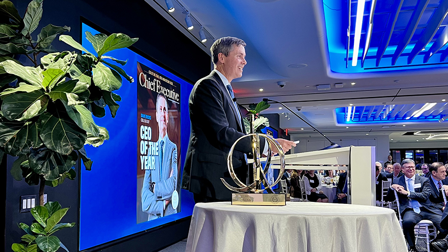 Man on stage accepting award