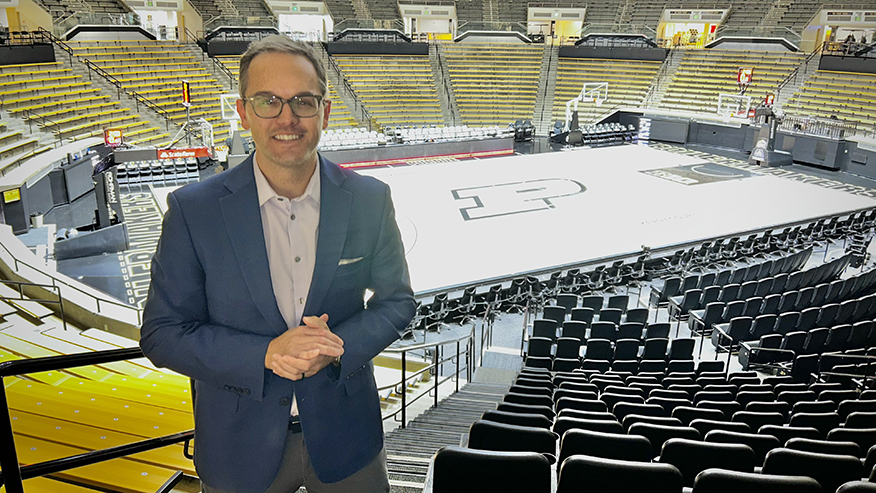 Pat Doney standing in Mackey Arena