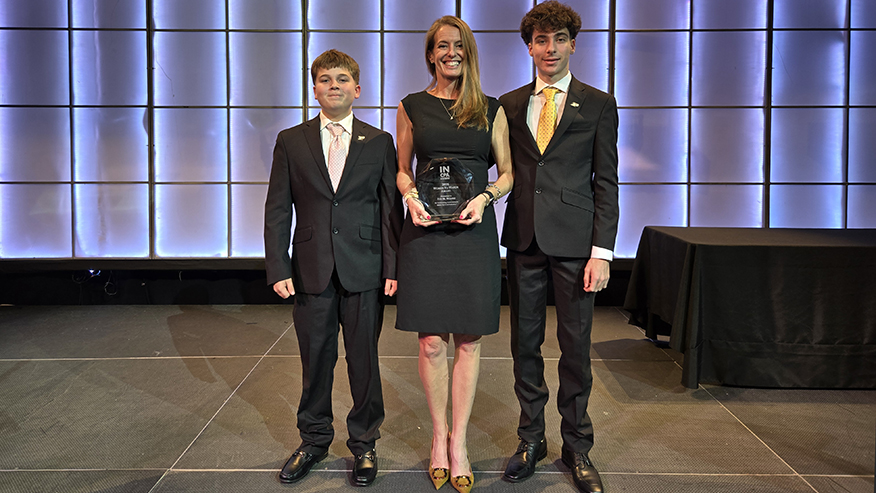 Eva Nodine with her award and two sons at the Indiana CPA Society annual dinner.